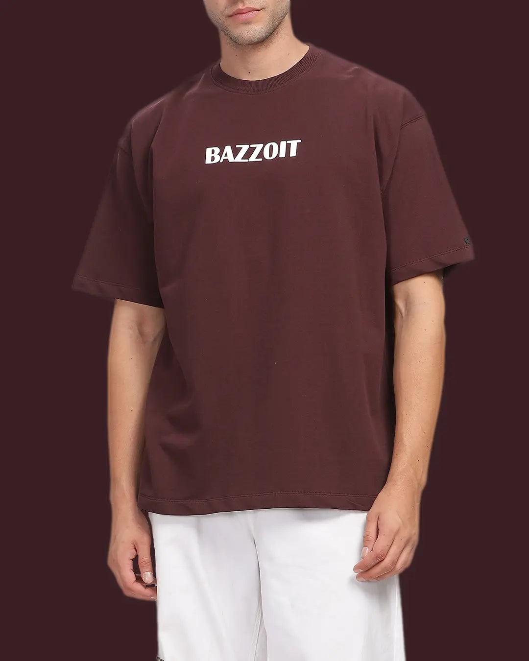 Person wearing a maroon t-shirt with 'BAZZOIT' text on a dark background