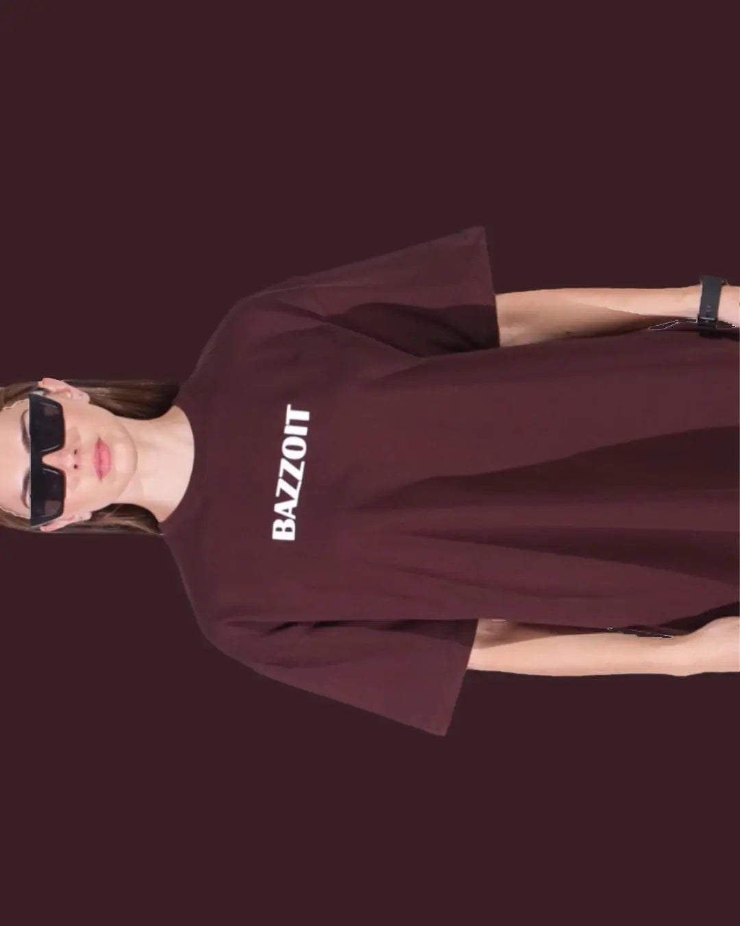 Person wearing a maroon sweatshirt with 'BAZZOTT' text on a dark background