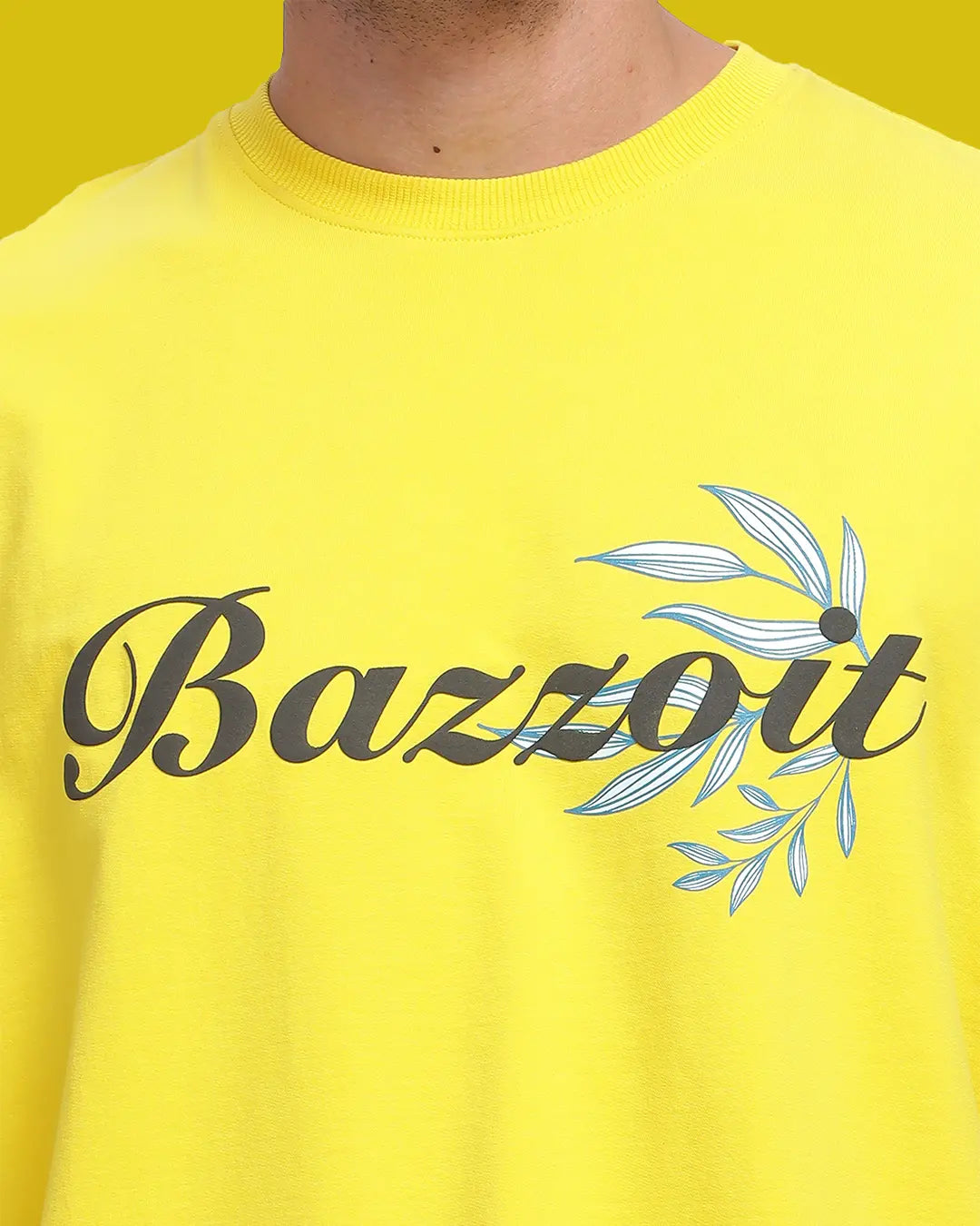 Yellow shirt with 'Bazzoit' text and leaf design on a yellow background