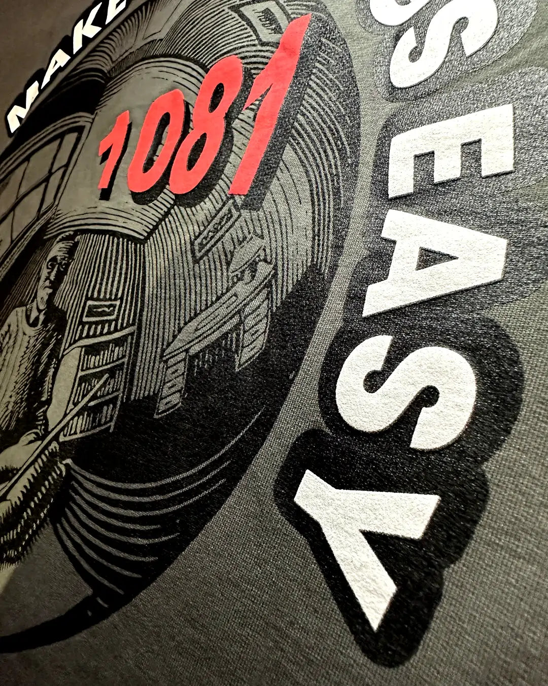 Product packaging with '1081' and 'MAKE ALL THINGS EASY' text on a gray t shirt