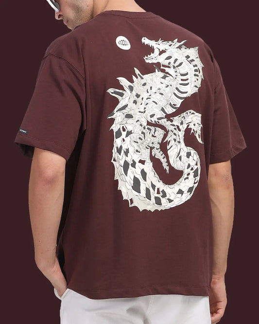 Person wearing a brown t-shirt with a white dragon design on the back against a dark background