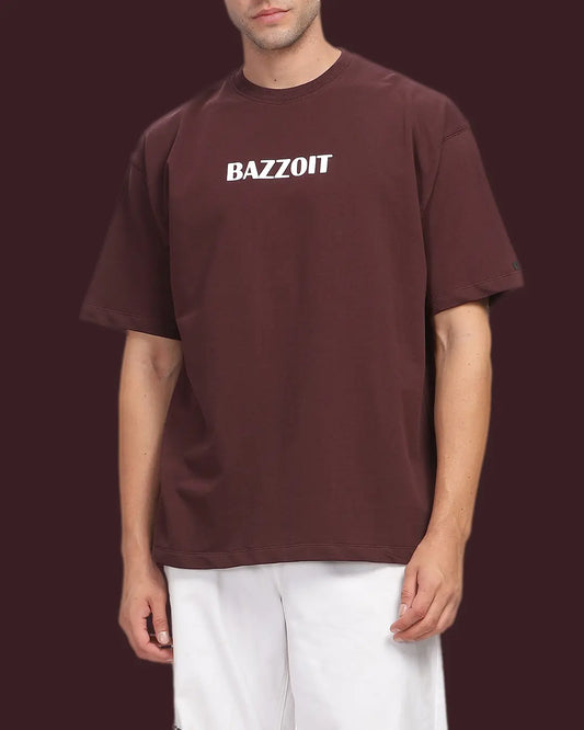 Person wearing a maroon t-shirt with 'BAZZOIT' text on a dark background