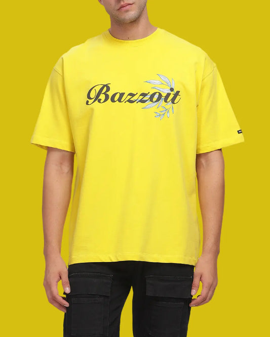 Person wearing a yellow t-shirt with 'Bazzott' logo on a yellow background